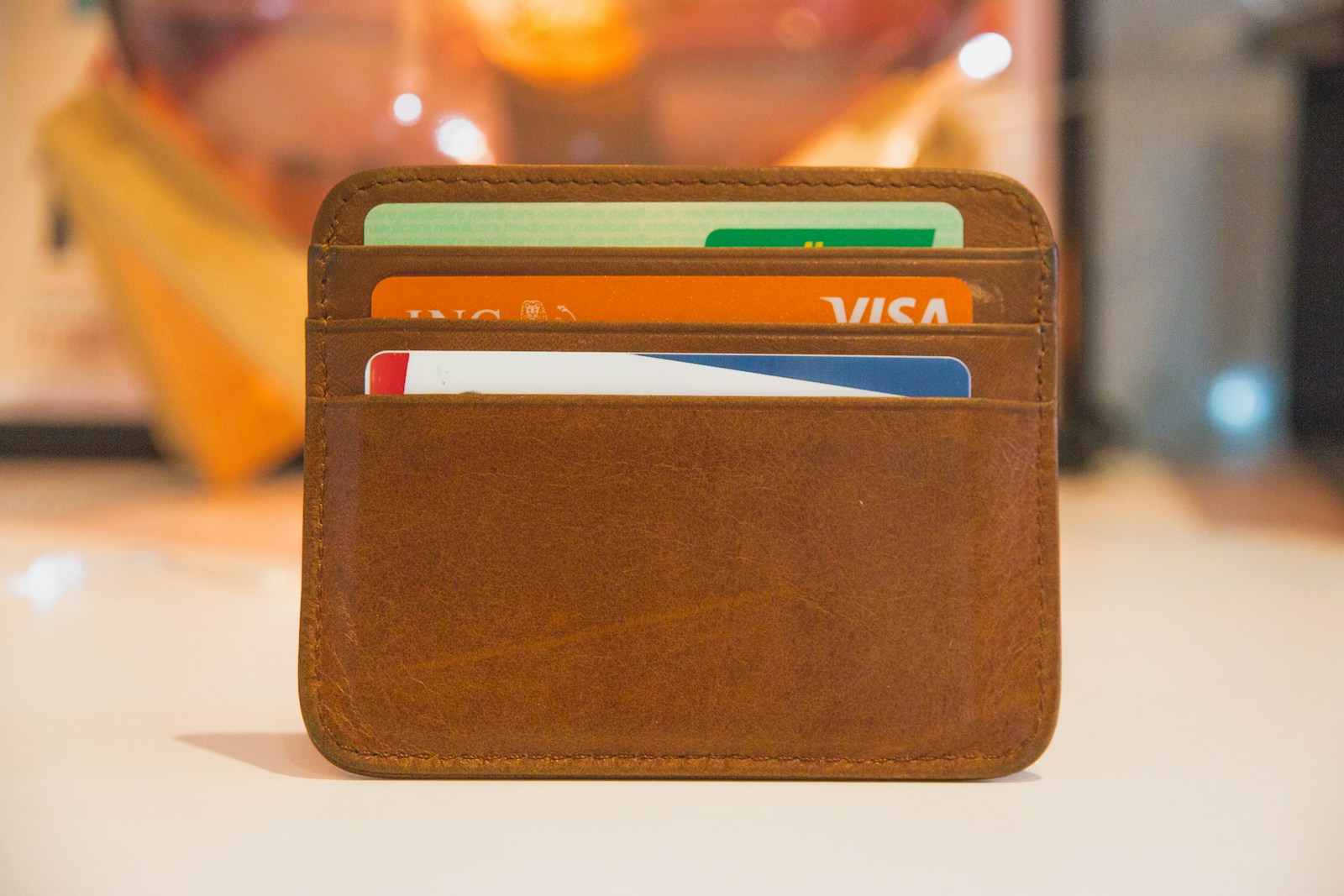 Cognac leather card wallet under warm studio light